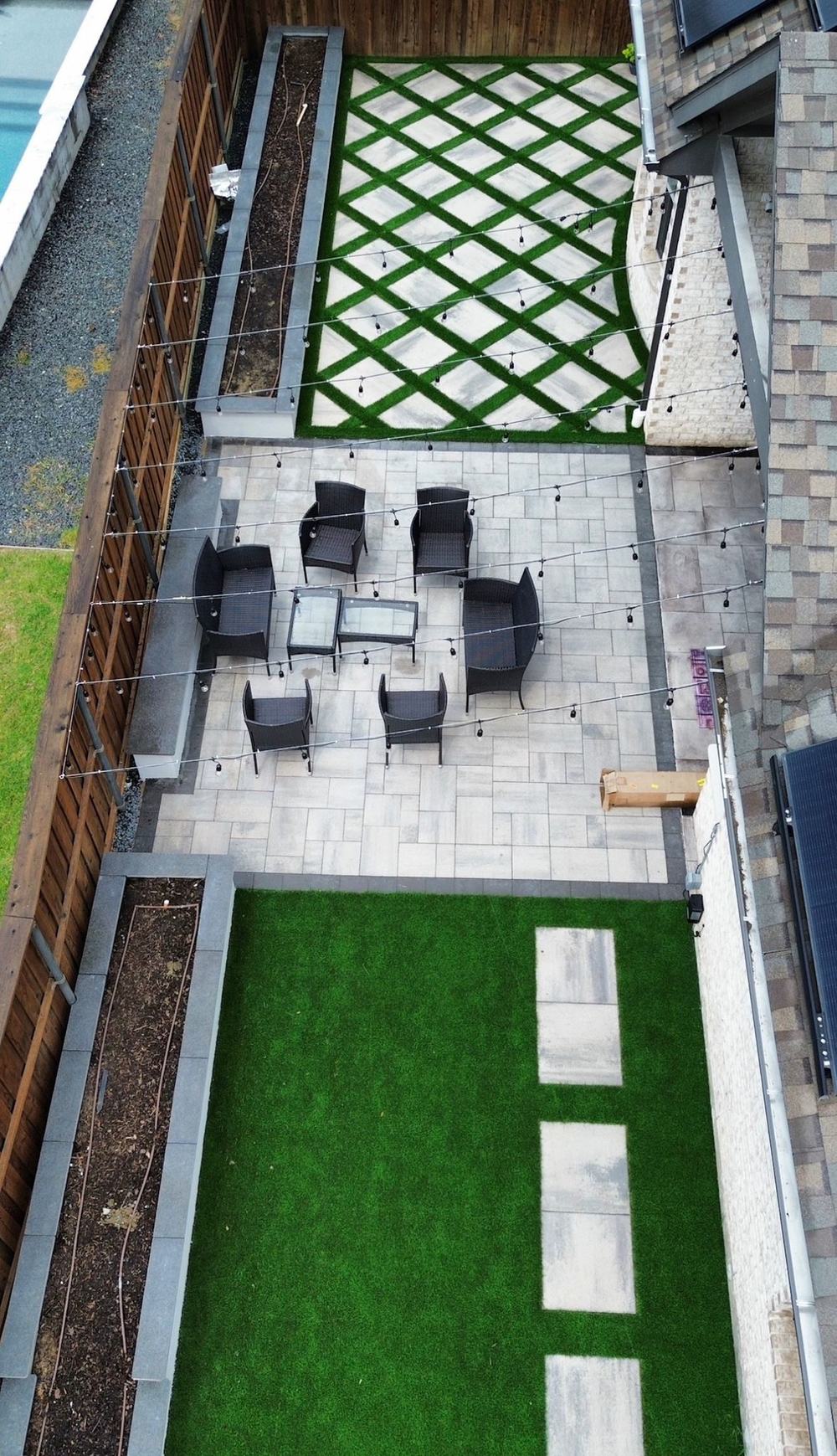 Paver patio with turf inlay and string lighting
