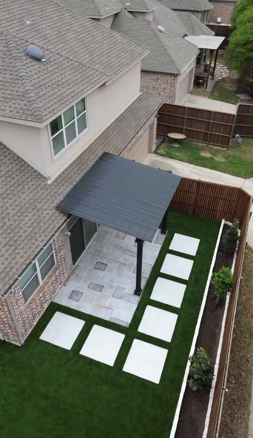 Aluminum patio cover with pavers and turf, aerial view